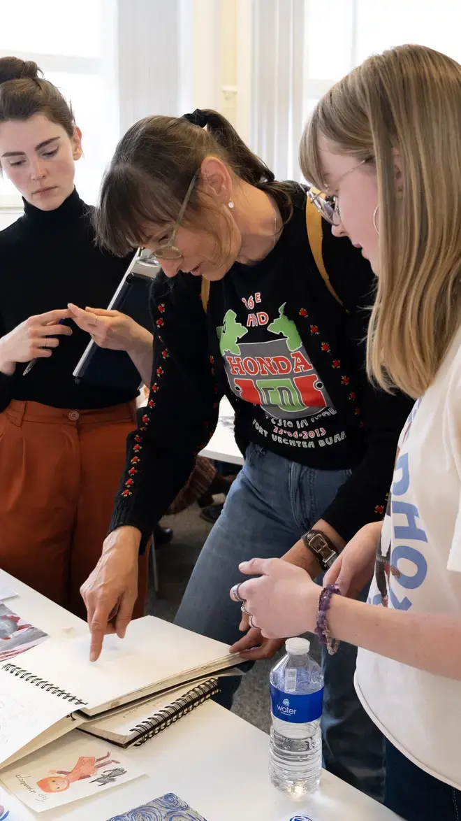 Visuele Communicatie - docent kijkt naar werk van studenten
